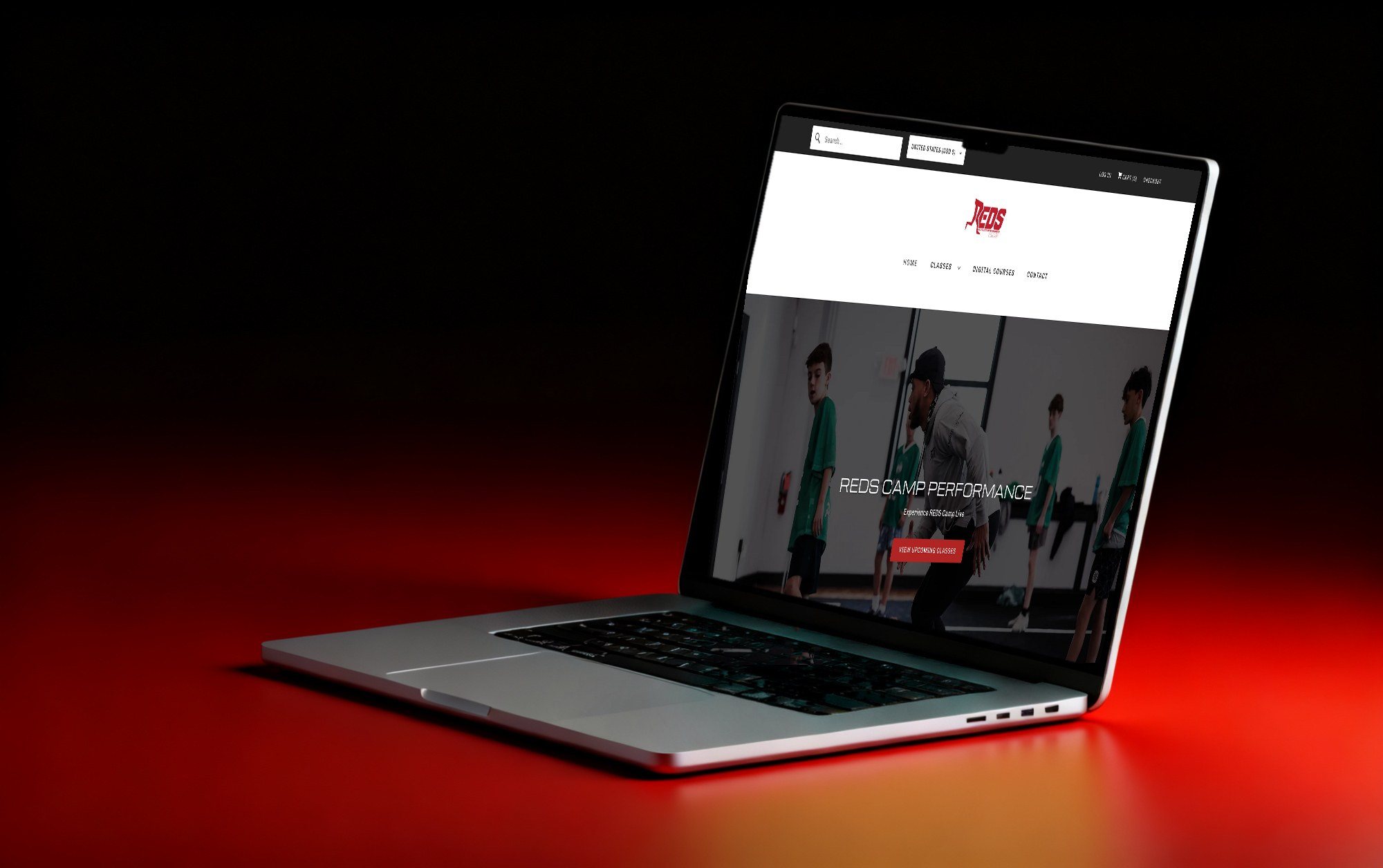 The Reds Camp homepage on a laptop: Reds Camp Performance, experience Reds Camp live